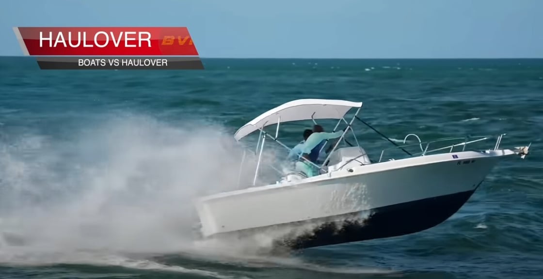 Small boat riding a haulover wave