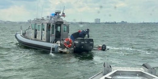 Chareslton harbor rescue in proccess with boat pulling people out of the water