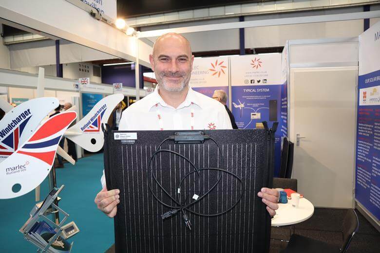 Sales-Manager-Stuart-James-holds-new-Spectra-Zipperflex-100W-solar-panels-11-29-25