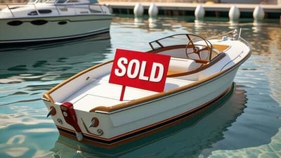 image of a small power boat with a red sold sign on it